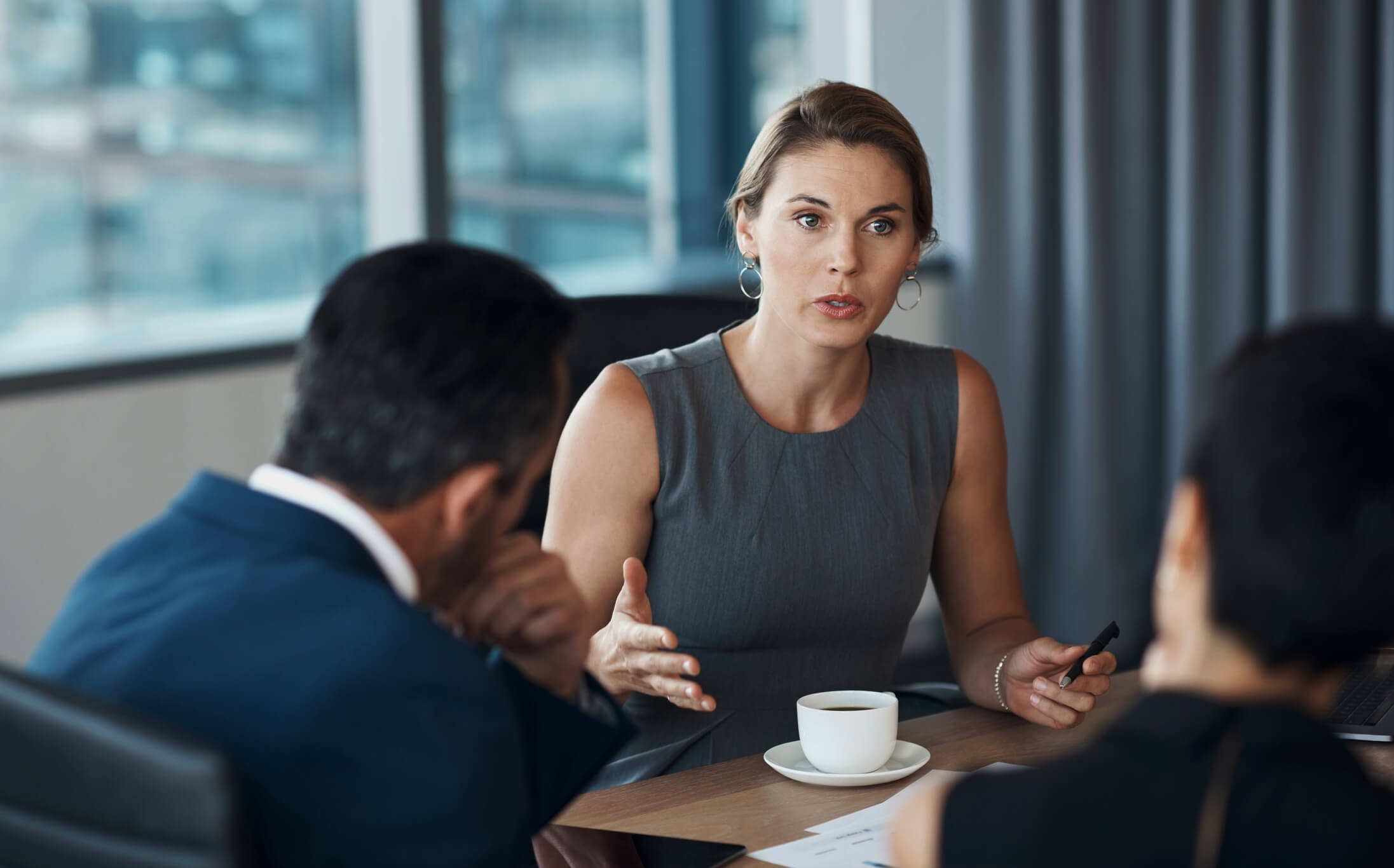 images/insights/2023/female-professional-mid-sentence-discussing-something-with-coworkers.jpg