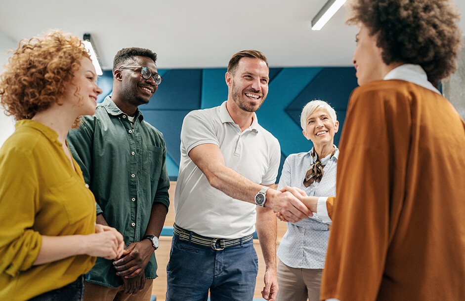 images/insights/2023/small-group-of-happy-people-smiling-and-shaking-hands.jpg