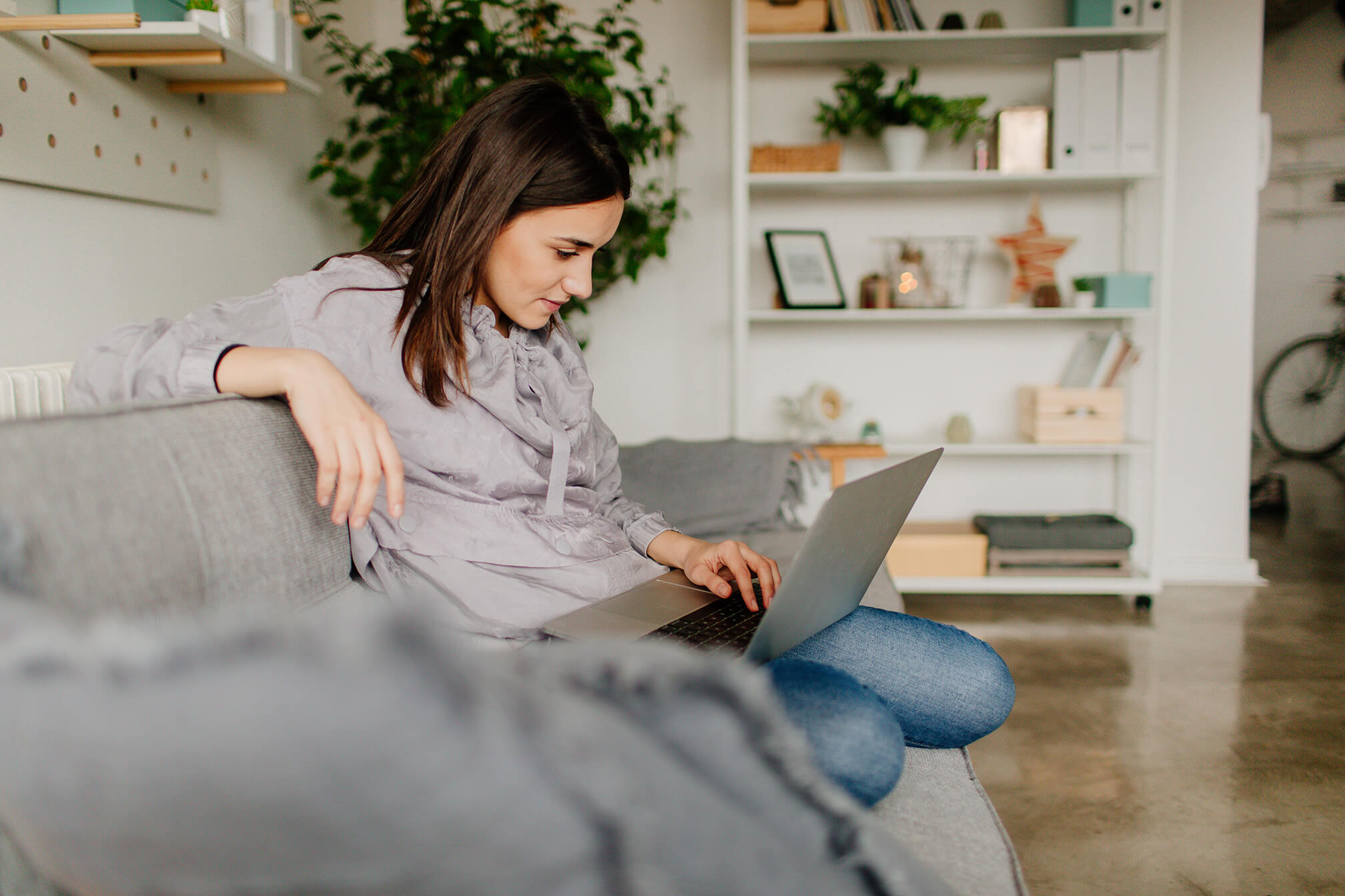 images/insights/2023/worried-female-looking-at-a-laptop-sitting-on-a-grey-couch.jpg
