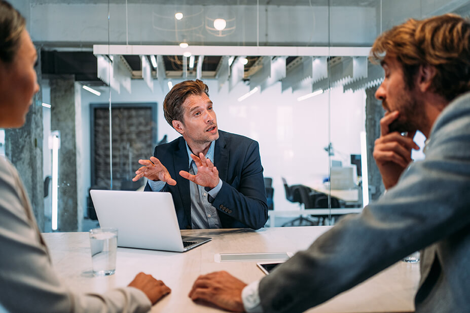 images/insights/2023/young-businessman-explaining-something-to-his-coworkers-in-a-modern-conference-room.jpg